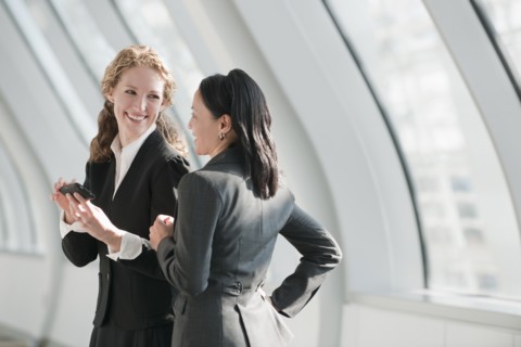 Businesswomen using at cell phone. Photo: Mark Edward Atkinson