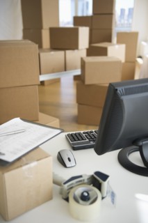 Boxes and computer at delivery warehouse.