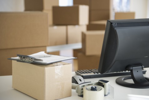 Boxes and computer at delivery warehouse.