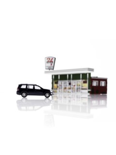 Toy car in front of toy gas station. Photo: David Arky