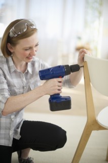 Woman repairing chair.