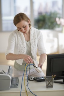 Woman installing router at home office.
