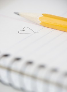 Close-up of pencil and notebook with heart drawing. Photo: Jamie Grill Photography