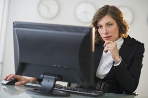Businesswoman working at desk in office.