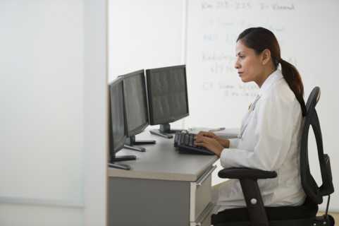 Female doctor making notes.