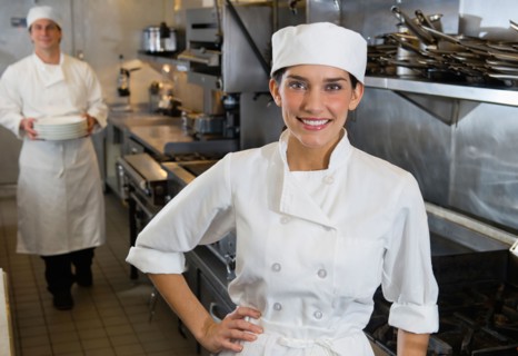 Chef and cook in commercial kitchen.