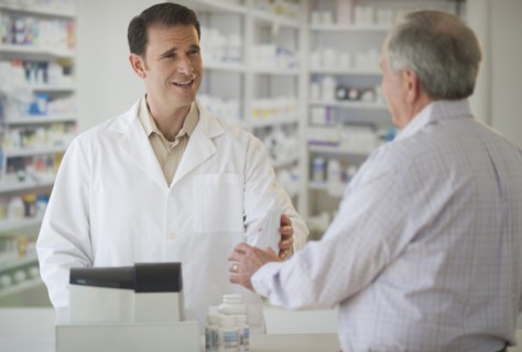 Pharmacist explaining use of medicine to patient.