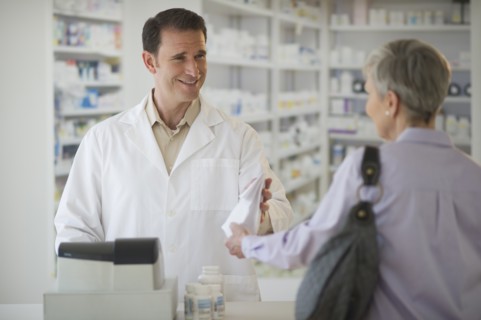 Senior woman talking to pharmacist.