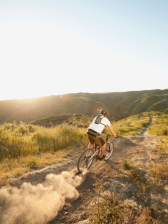 USA, California, Laguna Beach, Man cycling down hill.