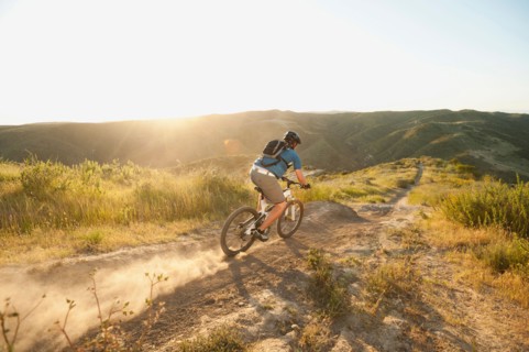 USA, California, Laguna Beach, Man cycling down hill.