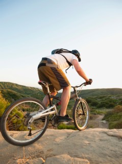 USA, California, Laguna Beach, Man cycling down hill.