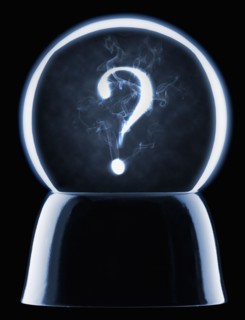 Studio shot of crystal ball showing question mark. Photo : Mike Kemp