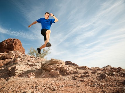 USA, Arizona, Phoenix, Mid adult man jogging on desert.
