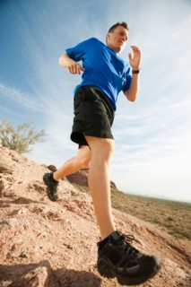 USA, Arizona, Phoenix, Mid adult man jogging on desert.