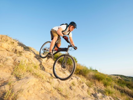 USA, California, Laguna Beach, Man cycling down hill.