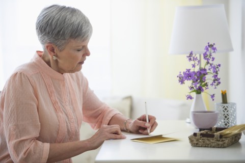 Senior woman writing letter.