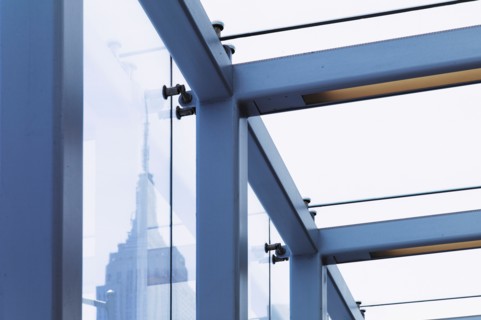 USA, New York, New York City, Empire State Building seen behind window frame.