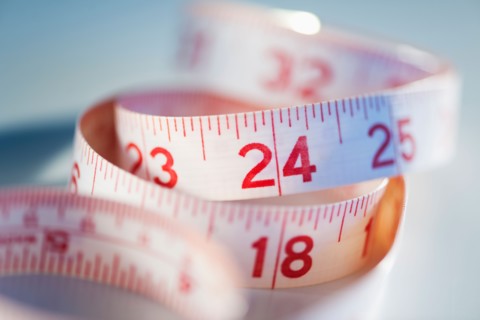 Close-up of measure tape, studio shot.