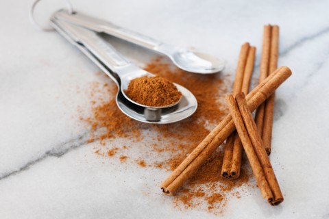 Studio shot of cinnamon stick and cinnamon powder.