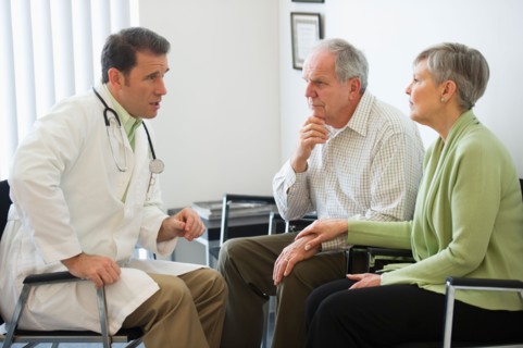 Senior couple talking to doctor.