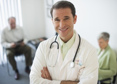 Portrait of doctor, senior couple in the background.