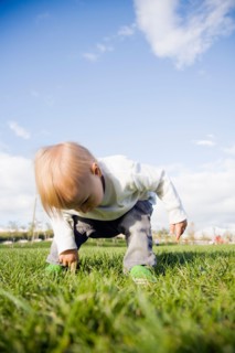 Baby boy (0-1 years) on grass. Photo : Maisie Paterson