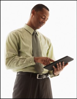 Content young businessman examining file. Photo : Mike Kemp