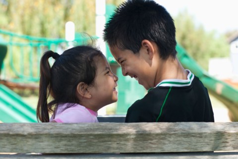 Brother and sister (4-13) face to face at playground. Photo : Noah Clayton