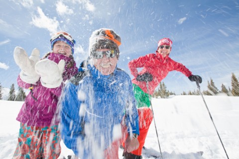 USA, Colorado, Telluride, Grandparents with girl (10-11) throwing snowballs at camera. Photo :