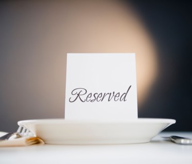 Reserved sign on place setting, studio shot. Photo : Jamie Grill Photography