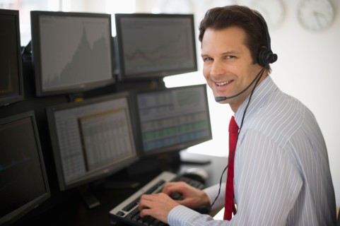 Portrait of financial worker analyzing data displayed on computer screen.
