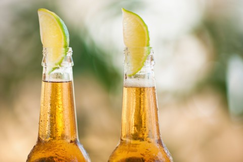 Two beer bottles with lime wedges.