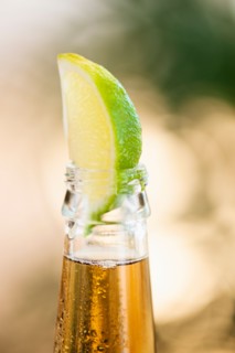 Beer bottle with lime wedge.