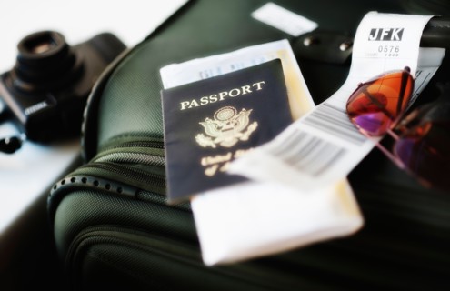 Close up of passport and travel accessories.