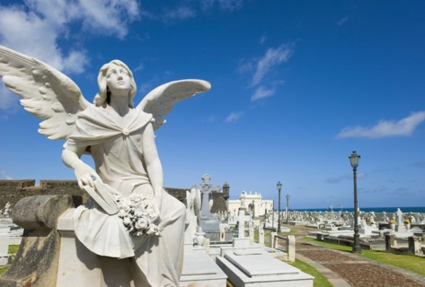 Puerto Rico, Old San Juan, Santa Maria Magdalena Cemetery with El Morro Fortress in background .