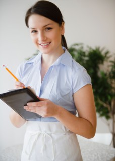 Portrait of smiling waitress taking order. Photo : Jamie Grill Photography