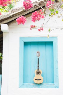 Brazil, Bahia, Trancoso, Guitar against building wall. Photo : Jamie Grill Photography