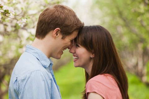 USA, Utah, Provo, Young couple face to face in orchard. Photo : Mike Kemp