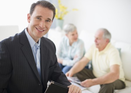 Portrait of businessman, senior couple in the background.