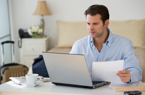 Man using laptop at home office.