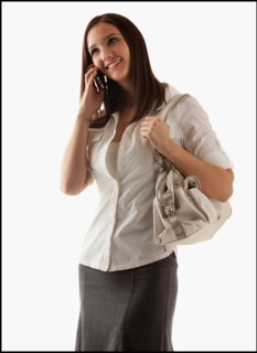Young attractive businesswoman using mobile phone. Photo : Mike Kemp