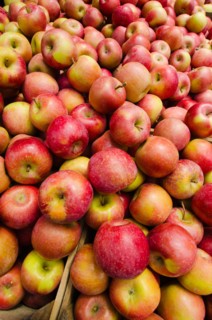 Stack of apples on market stall.