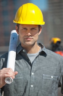 Portrait of worker holding blueprint.