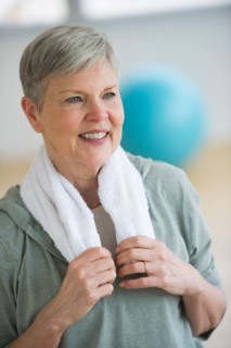 Smiling senior woman in gym.