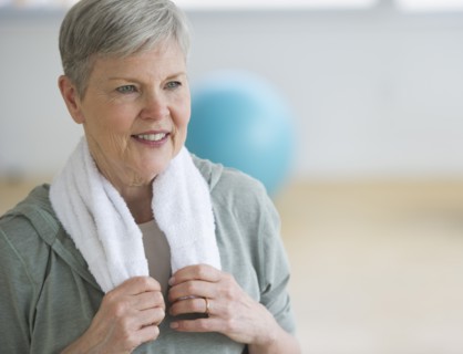 Smiling senior woman in gym.