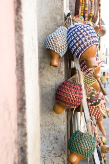 Brazil, Bahia, Salvador De Bahia, Rattles hanging against wall, close-up. Photo : Jamie Grill