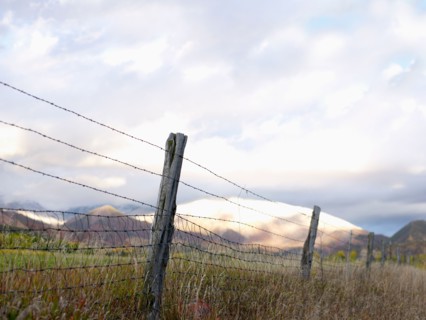 USA, Colorado, Mountain landscape with fence in foreground. Photo : John Kelly