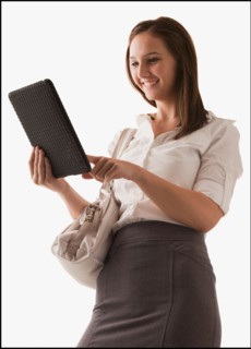 Studio shot of young woman with digital tablet. Photo : Mike Kemp
