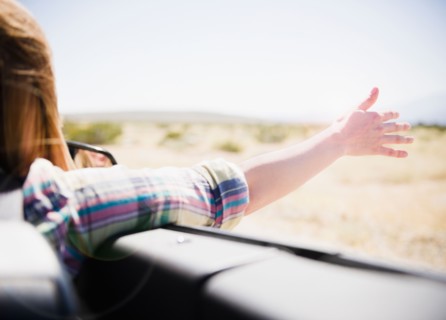 USA, California, Palm Springs, Coachella Valley, San Gorgonio Pass, Woman stretching arm outside