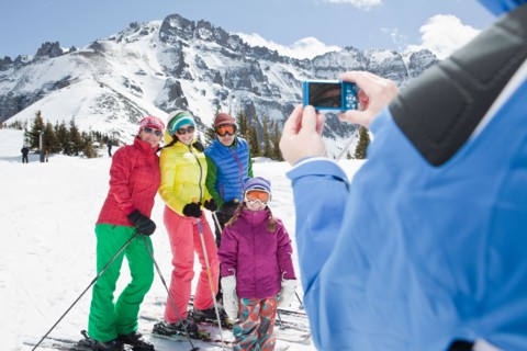 USA, Colorado, Telluride, Three-generation family with girl (10-11) posing during ski holiday.